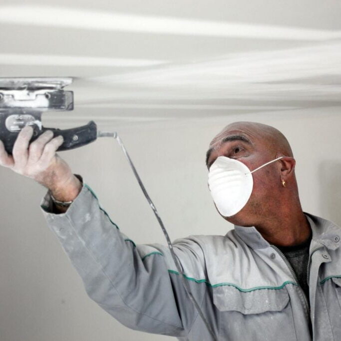 repairman cleaning the ceiling